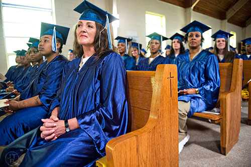 Teresa Kohnle (left) waits to receive her certificate during the graduation ceremony for theological studies at the Lee Arrendale Correctional Facility in Alto on Friday, April 10, 2015. 