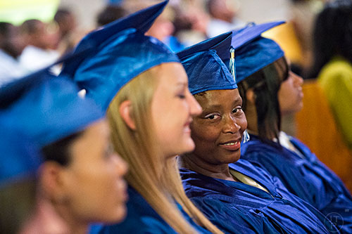 Lorraine McKnight (right) waits to receive her certificate during the graduation ceremony for theological studies at the Lee Arrendale Correctional Facility in Alto on Friday, April 10, 2015. 