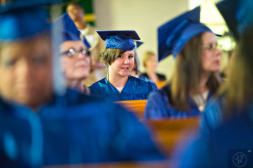 Lenna Highland (center) waits to receive her certificate during the graduation ceremony for theological studies at the Lee Arrendale Correctional Facility in Alto on Friday, April 10, 2015. 