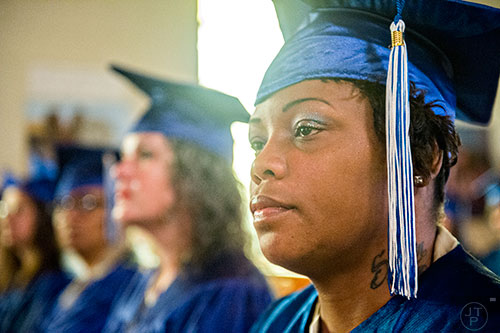 Natasha Demery (right) waits to receive her certificate during the graduation ceremony for theological studies at the Lee Arrendale Correctional Facility in Alto on Friday, April 10, 2015.