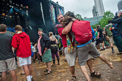 Matt Granato (center) dances with Jeff Morgan during the last day of the SweetWater 420 Fest at Centennial Olympic Park in Atlanta on Sunday, April 19, 2015.