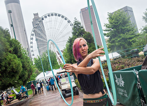 Charlotte Dillard dances with hula hoops during the last day of the SweetWater 420 Fest at Centennial Olympic Park in Atlanta on Sunday, April 19, 2015.
