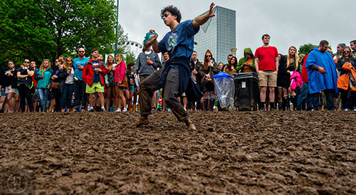 Jeremy Heit dances in the mud during the last day of the SweetWater 420 Fest at Centennial Olympic Park in Atlanta on Sunday, April 19, 2015. 