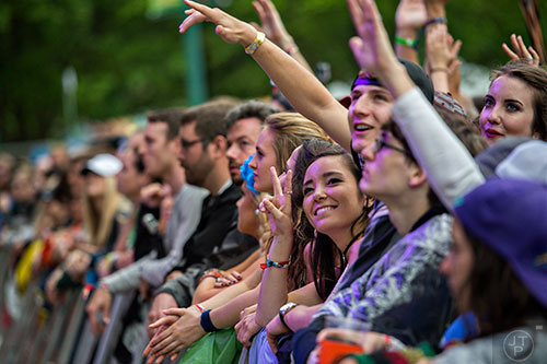 Shannen Galvin (center) watches The Revivalists perform during the last day of the SweetWater 420 Fest at Centennial Olympic Park in Atlanta on Sunday, April 19, 2015. 