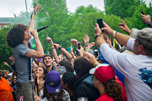 The Revivalists'  David Shaw (left) performs right in front of the crowd during the last day of the SweetWater 420 Fest at Centennial Olympic Park in Atlanta on Sunday, April 19, 2015.
