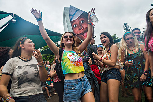 Paloma Whatley (left), Michelle Patton and Carisa Urrea dance during the last day of the SweetWater 420 Fest at Centennial Olympic Park in Atlanta on Sunday, April 19, 2015. 