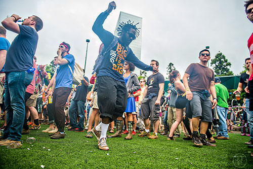 Ashdon Gibbs (center) dances during the last day of the SweetWater 420 Fest at Centennial Olympic Park in Atlanta on Sunday, April 19, 2015.