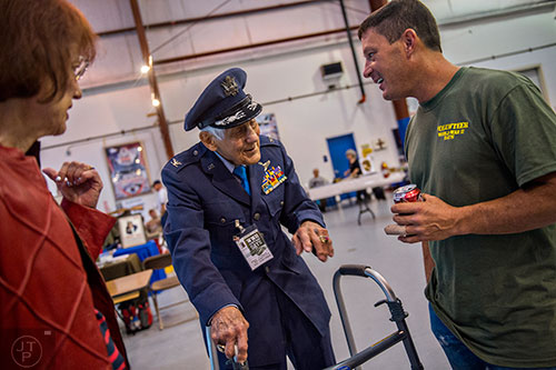 World War II veteran Paul Koshewa (center) and his wife Marilyn Schwab talk with Brendon Martelino during WWII Heritage Days at Atlanta Regional Airport Falcon Field in Peachtree City on Sunday, April 19, 2015. 