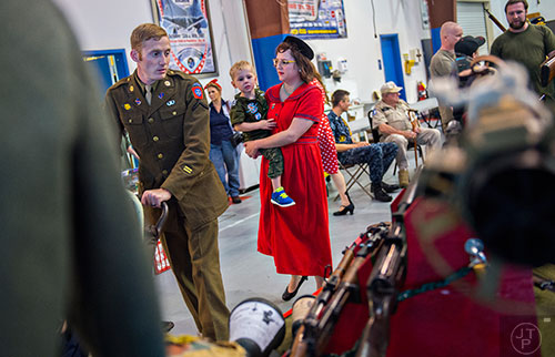 Josh Goetze (left), his son Austin and wife Amy look at World War II memorabilia during WWII Heritage Days at Atlanta Regional Airport Falcon Field in Peachtree City on Sunday, April 19, 2015. 