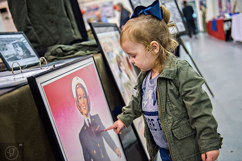Braylei Davis points to a woman on a piece of World War II memorabilia during WWII Heritage Days at Atlanta Regional Airport Falcon Field in Peachtree City on Sunday, April 19, 2015. 