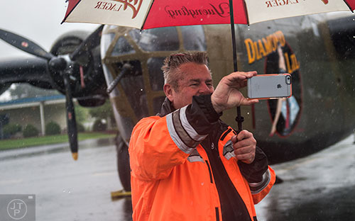 Hollywood Heard takes a selfie in front of a World War II era B-24 bomber during WWII Heritage Days at Atlanta Regional Airport Falcon Field in Peachtree City on Sunday, April 19, 2015. 