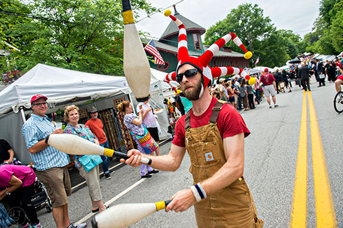 Brandon Ross (center) juggles as he marches in the parade during the Inman Park Festival in Atlanta on Saturday, April 25, 2015. 