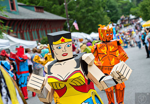 Dressed as a Wonder Woman box head, Anke Larkworthy marches in the parade during the Inman Park Festival in Atlanta on Saturday, April 25, 2015. 
