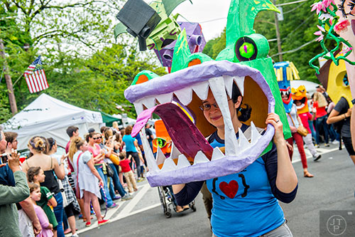 Kitty Quitmeyer (center) walks in the parade wearing a giant cardboard head during the Inman Park Festival in Atlanta on Saturday, April 25, 2015. 