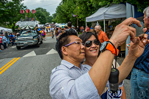 Mai Ching (right) and her husband Felipe take a selfie in front of the parade during the Inman Park Festival in Atlanta on Saturday, April 25, 2015. 
