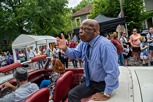 Congressman John Lewis blows kisses to the crowd as he rides in the parade during the Inman Park Festival in Atlanta on Saturday, April 25, 2015. 