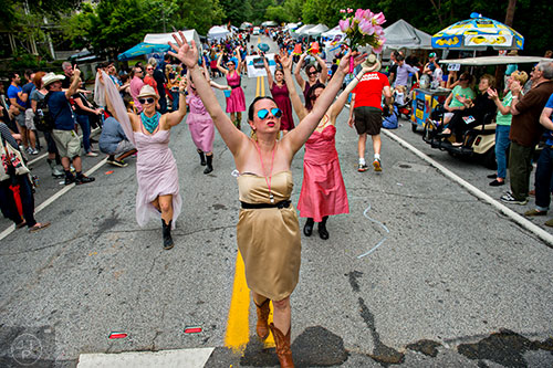 Dana Lee (center) leads the Bridesmaid Brigade down the parade route during the Inman Park Festival in Atlanta on Saturday, April 25, 2015.