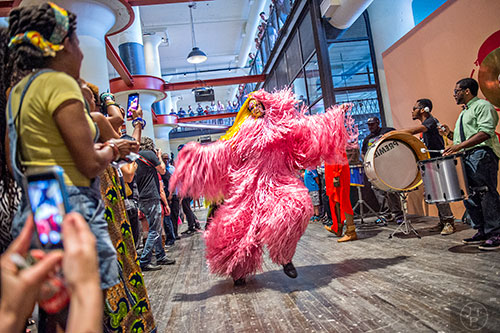A dancer makes their way through the crowd during Nick Cave's Up Right: Atlanta performance at Ponce City Market on Sunday, April 26, 2015.