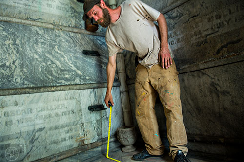 S Bedford measures one of the crypts at Oakland Cemetery in Atlanta on Sunday, April 26, 2015. 