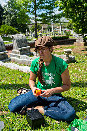 Neta Gary installs her exhibit on one of the grave plots at Oakland Cemetery in Atlanta on Sunday, April 26, 2015. 