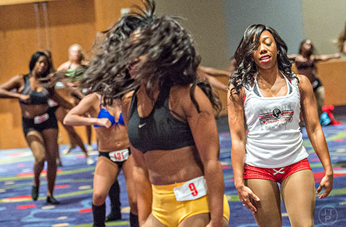 Current Falcons cheerleader Kristen Johnson (right) runs through a dance routine with hopeful Camesha Pierce before first cut tryouts begin for the Atlanta Falcons Cheerleaders at the Georgia International Convention Center in Atlanta on Sunday, May 3, 2015. 