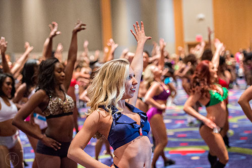 Summer Wales (center) runs through her dance routine before first cut tryouts begin for the Atlanta Falcons Cheerleaders at the Georgia International Convention Center in Atlanta on Sunday, May 3, 2015. 
