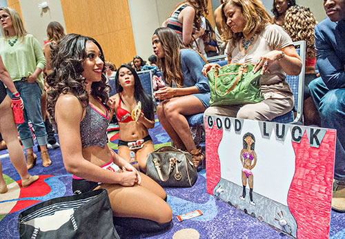 Diamond Jack (left) kneels next to her mother Margo as she waits to find out who moves on to the second round of tryouts for the Atlanta Falcons Cheerleaders at the Georgia International Convention Center in Atlanta on Sunday, May 3, 2015. 