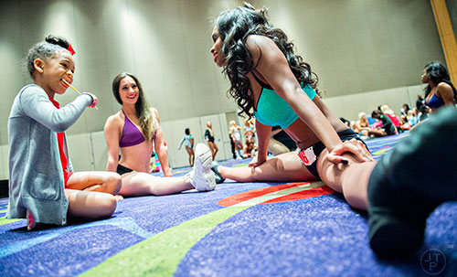 Kymberly Whitehall (right) and Heather Dessaint talk to Skye Jones as they wait to find out who moves on to the second round of tryouts for the Atlanta Falcons Cheerleaders at the Georgia International Convention Center in Atlanta on Sunday, May 3, 2015. 