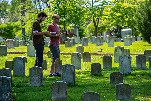 Scott Crossley (left) and Steve Chrestman walk past grave stones during the Arts at Oakland presents Roam Transmissions' The Cryptophonic Tour at Oakland Cemetery in Atlanta on Saturday, May 2, 2015. 