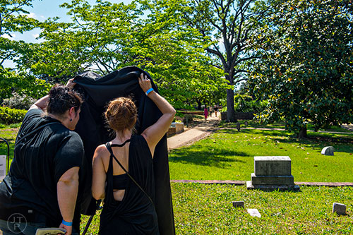 Stephanie Pope (left) and Christie Priode look at Chris Devoe's sound installation during the Arts at Oakland presents Roam Transmissions' The Cryptophonic Tour at Oakland Cemetery in Atlanta on Saturday, May 2, 2015. 