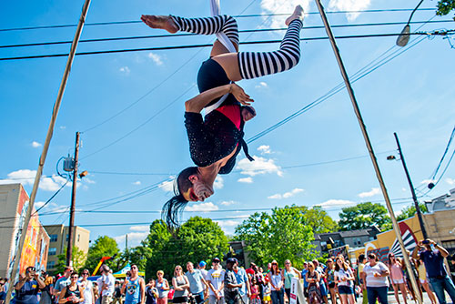 Nicolette Emanuelle performs on a set of silks during the Fire in the Fourth Festival in the Old Fourth Ward neighborhood of Atlanta on Saturday, May 2, 2015. 