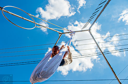 Jake Guinn performs on a set of silks during the Fire in the Fourth Festival in the Old Fourth Ward neighborhood of Atlanta on Saturday, May 2, 2015. 