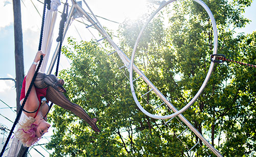 Vivian Kyle performs on the trapeze during the Fire in the Fourth Festival in the Old Fourth Ward neighborhood of Atlanta on Saturday, May 2, 2015. 