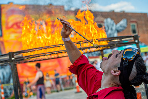 Tim Mack consumes a fire torch during the Fire in the Fourth Festival in the Old Fourth Ward neighborhood of Atlanta on Saturday, May 2, 2015. 