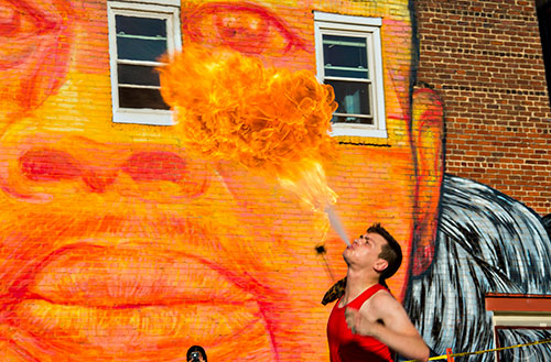 Zac Ogilvie, known as Binx, breathes fire during the Fire in the Fourth Festival in the Old Fourth Ward neighborhood of Atlanta on Saturday, May 2, 2015. 