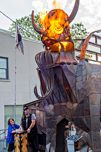 Charlie Smith (right) and his son Casper Xan Smith-Ladet operate the fire sculpture created by Smith during the Fire in the Fourth Festival in the Old Fourth Ward neighborhood of Atlanta on Saturday, May 2, 2015. 