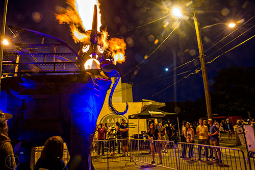 Fire pours out of the sculpture created by Charlie Smith during the Fire in the Fourth Festival in the Old Fourth Ward neighborhood of Atlanta on Saturday, May 2, 2015. 