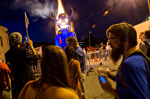 Fire pours out of the sculpture created by Charlie Smith during the Fire in the Fourth Festival in the Old Fourth Ward neighborhood of Atlanta on Saturday, May 2, 2015. 