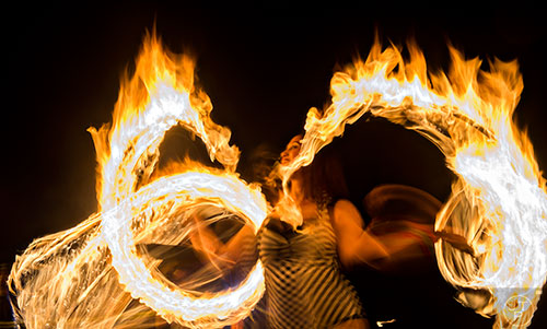 Ann Marie Spexet spins fire during the Fire in the Fourth Festival in the Old Fourth Ward neighborhood of Atlanta on Saturday, May 2, 2015.