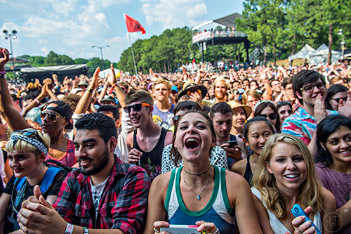 Jake Guerra (left), Isabella Groff and Katie Nyquist cheer as Mac DeMarco performs during the first day of the Shaky Knees Music Festival at Central Park in Atlanta on Friday, May 8, 2015. 