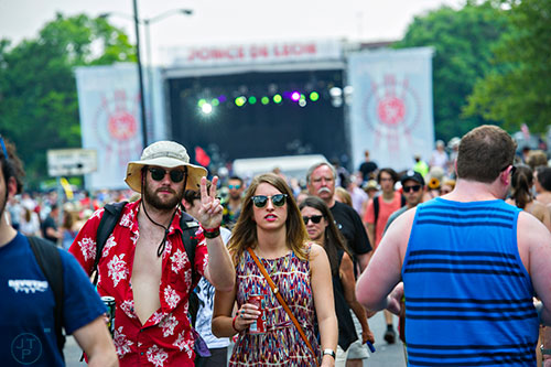 Timothy Bolden (left) and Olivia Overstreet walk toward another stage during the first day of the Shaky Knees Music Festival at Central Park in Atlanta on Friday, May 8, 2015. 