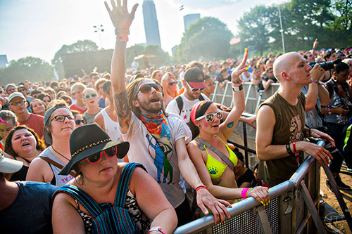 Jared Brady (center left) and his girlfriend Jessica Thomas dance as TV on the Radio performs on stage during the first day of the Shaky Knees Music Festival at Central Park in Atlanta on Friday, May 8, 2015. 