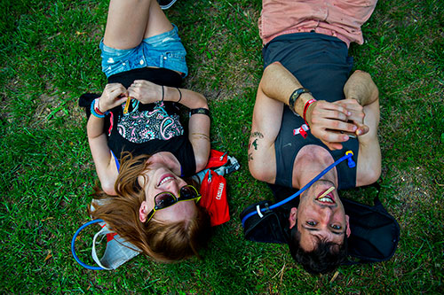 Amanda Garceau (left) and Bryan Tarcitano lay in the grass during the first day of the Shaky Knees Music Festival at Central Park in Atlanta on Friday, May 8, 2015. 