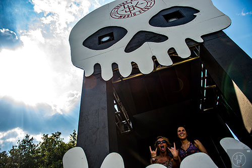 Mary Lyle Smith (left) and Andrea Fuhrman pose in a photo booth during the first day of the Shaky Knees Music Festival at Central Park in Atlanta on Friday, May 8, 2015. 
