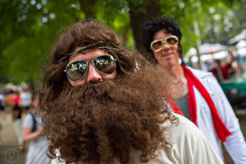 Dressed as Jesus and Elvis, Kyle Hurlbut (left) and Ryan O'Heron walk toward the Peachtree Stage during the Shaky Knees Music Festival at Central Park in Atlanta on Saturday, May 9, 2015.
