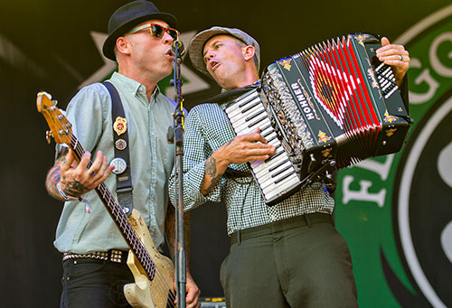 Flogging Molly's Matt Hensley (right) and Nathen Maxwell perform on stage during the Shaky Knees Music Festival at Central Park in Atlanta on Saturday, May 9, 2015. 