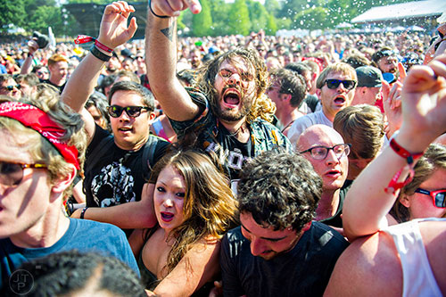 Manny Vazquez (center) thrashes in a mosh pit during the Shaky Knees Music Festival at Central Park in Atlanta on Saturday, May 9, 2015. 