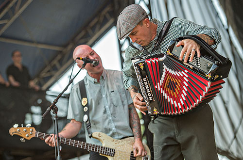 Flogging Molly's Matt Hensley (right) and Nathen Maxwell perform on stage during the Shaky Knees Music Festival at Central Park in Atlanta on Saturday, May 9, 2015. 