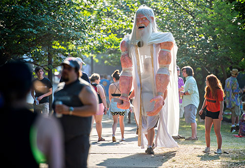 Dressed as Zeus, Cameron Hagan walks through the crowd during the Shaky Knees Music Festival at Central Park in Atlanta on Saturday, May 9, 2015. 
