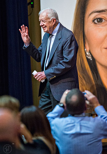 Former U.S. President Jimmy Carter waves as he exits the inaugural World Summit to End Sexual Exploitation at the Carter Center in Atlanta on Tuesday, May 12, 2015.    